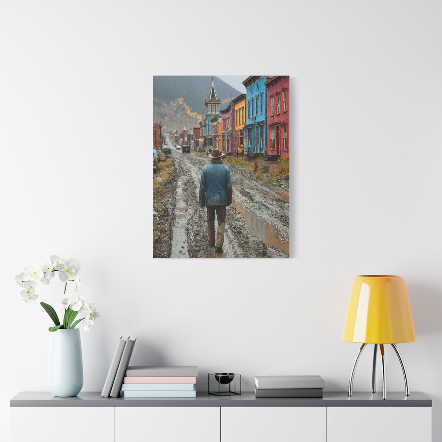 Lone Cowboy Walking Through a Rainy Frontier Street Wall Art & Canvas Print