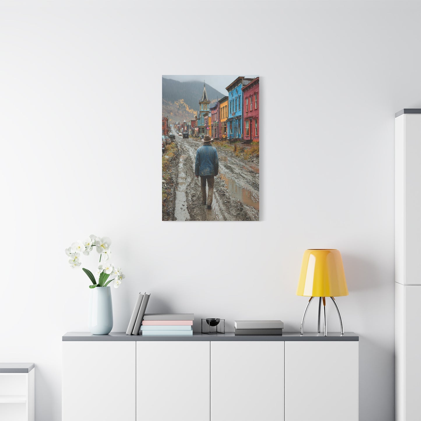 Lone Cowboy Walking Through a Rainy Frontier Street Wall Art & Canvas Print